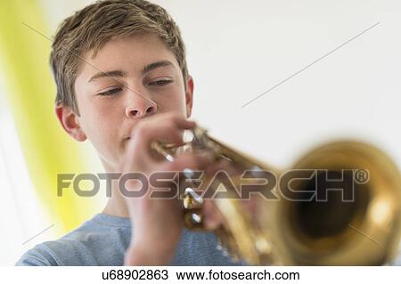 Teenage boy (16-17) playing trumpet View Large Photo Image Stock Image - Teenage boy (16-17) playing trumpet. Fotosearch