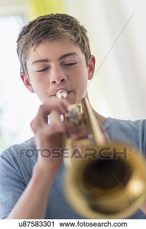 Teenage boy (16-17) playing trumpet View Large Photo Image Stock Image - Teenage boy (16-17) playing trumpet. Fotosearch