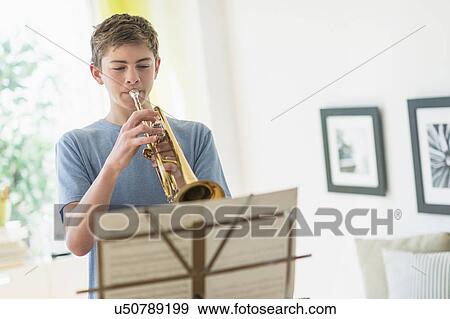 Teenage boy (16-17) playing trumpet View Large Photo Image Stock Photo - Teenage boy (16-17) playing trumpet. Fotosearch