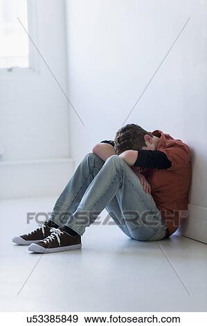 Teenage boy (16-17) sitting in hallway View Large Photo Image Stock Photo - Teenage boy (16-17) sitting in hallway. Fotosearch