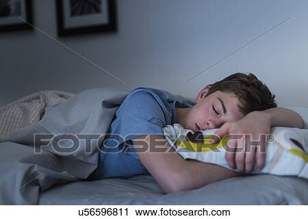 Teenage boy (16-17) sleeping in bed View Large Photo Image Stock Image - Teenage boy (16-17) sleeping in bed. Fotosearch