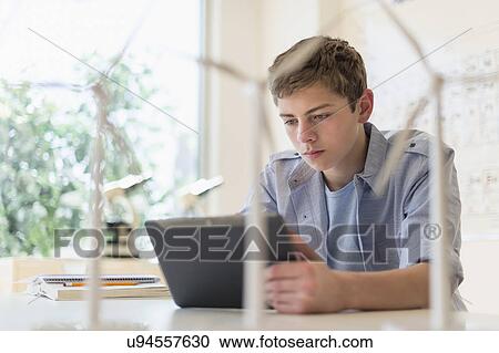 Teenage boy (16-17) using digital tablet in laboratory View Large Photo Image Stock Image - Teenage boy (16-17) using digital tablet in laboratory. Fotosearch