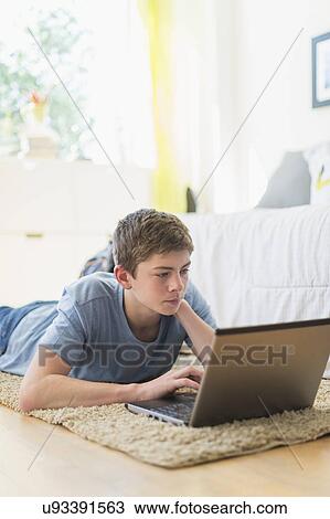 Teenage boy (16-17) using laptop View Large Photo Image Stock Image - Teenage boy (16-17) using laptop. Fotosearch