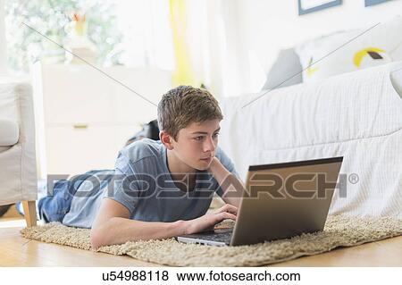Teenage boy (16-17) using laptop View Large Photo Image Stock Photo - Teenage boy (16-17) using laptop. Fotosearch