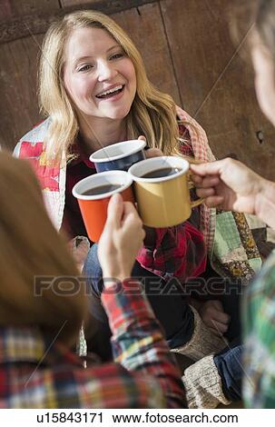 Stock Image - Three women toasting. Fotosearch