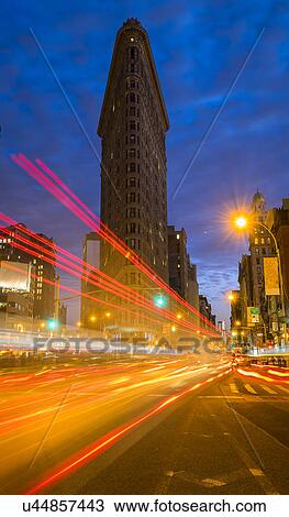 Stock Image - Traffic at night, Flatiron building in background. Fotosearch