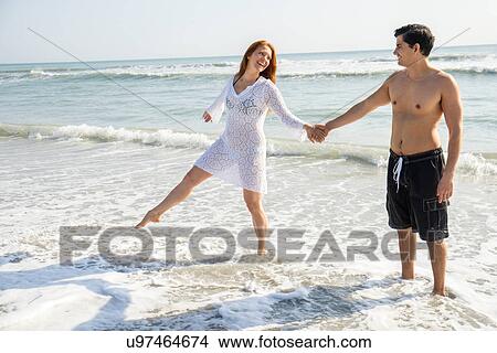 Picture - View of couple on beach. Fotosearch
