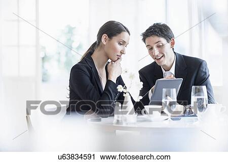 Stock Image - Woman and man at business lunch. Fotosearch