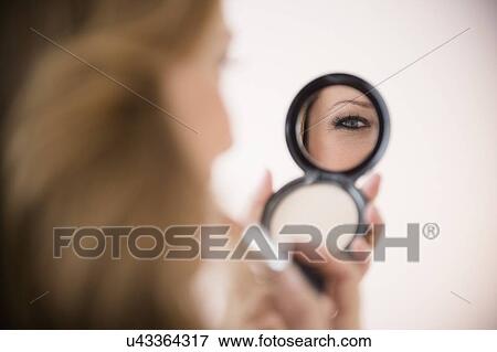 Woman applying makeup View Large Photo Image Stock Photo - Woman applying makeup. Fotosearch