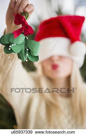 Woman colding christmas decoration View Large Photo Image Stock Photo - Woman colding christmas decoration. Fotosearch
