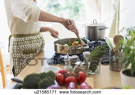Woman cooking in kitchen View Large Photo Image Stock Image - Woman cooking in kitchen. Fotosearch