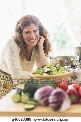 Woman cooking in kitchen View Large Photo Image Stock Photo - Woman cooking in kitchen. Fotosearch