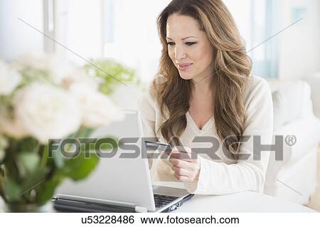 Woman doing online shopping on laptop View Large Photo Image Stock Photograph - Woman doing online shopping on laptop. Fotosearch