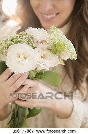 Stock Photo - Woman holding bouquet. Fotosearch