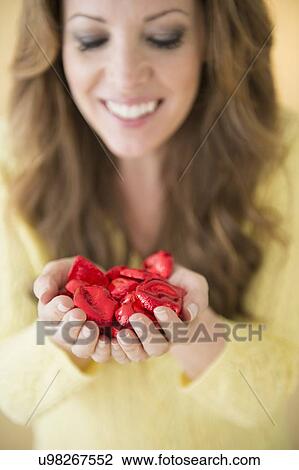 Woman holding chocolates in cupped hands View Large Photo Image Stock Image - Woman holding chocolates in cupped hands. Fotosearch