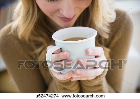 Woman holding coffee mug View Large Photo Image Picture - Woman holding coffee mug. Fotosearch