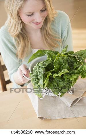 Woman holding colader full with kale View Large Photo Image Stock Image - Woman holding colader full with kale. Fotosearch