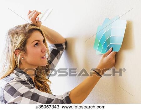 Stock Image - Woman holding color swatch. Fotosearch