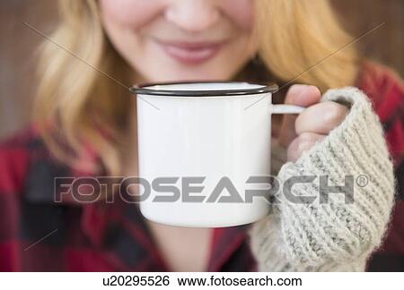 Woman holding metal coffee mug View Large Photo Image Stock Photograph - Woman holding metal coffee mug. Fotosearch