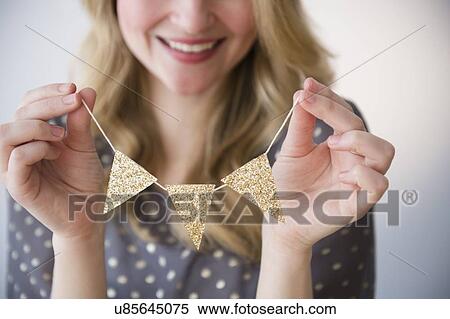 Stock Photography - Woman holding small gold banner. Fotosearch