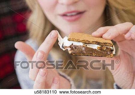 Stock Image - Woman holding smores. Fotosearch
