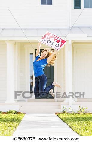 Woman jumping in front of new house View Large Photo Image Stock Photo - Woman jumping in front of new house. Fotosearch