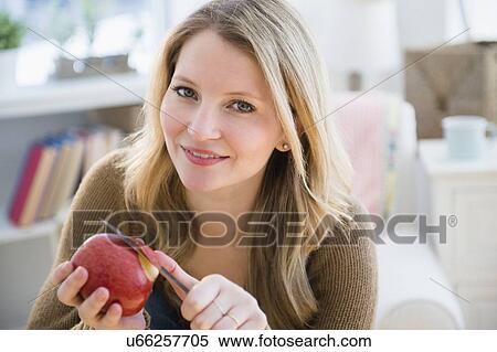 Woman peeling apple View Large Photo Image Stock Photography - Woman peeling apple. Fotosearch