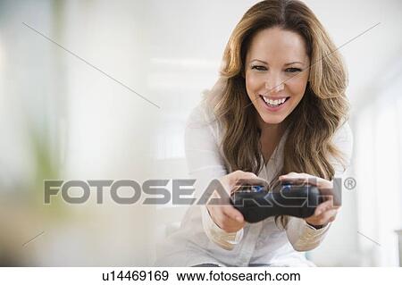 Stock Photo - Woman playing video game. Fotosearch