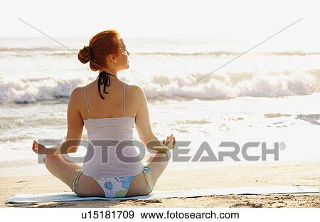 Woman practicing yoga on beach View Large Photo Image Stock Photo - Woman practicing yoga on beach. Fotosearch