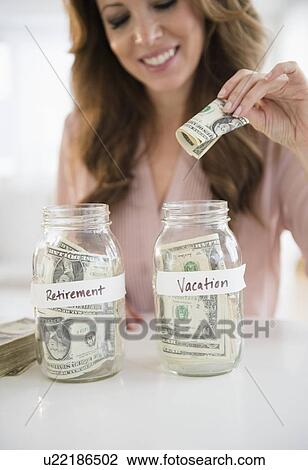 Woman putting money in jar View Large Photo Image Stock Image - Woman putting money in jar. Fotosearch