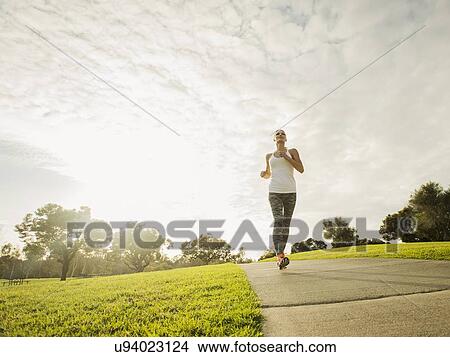 Woman running in park View Large Photo Image Picture - Woman running in park. Fotosearch