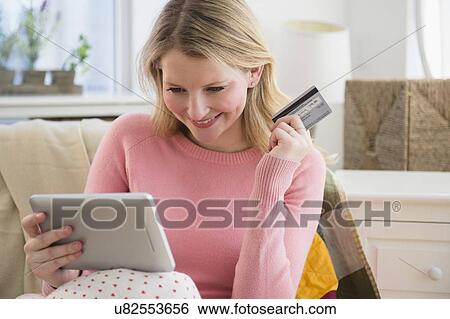 Stock Photograph - Woman shopping online. Fotosearch