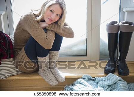 Stock Photo - Woman sitting on door stoop. Fotosearch