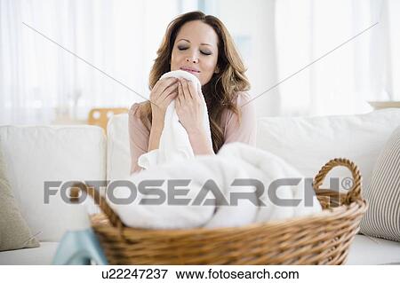 Woman smelling washed laundry View Large Photo Image Stock Photo - Woman smelling washed laundry. Fotosearch