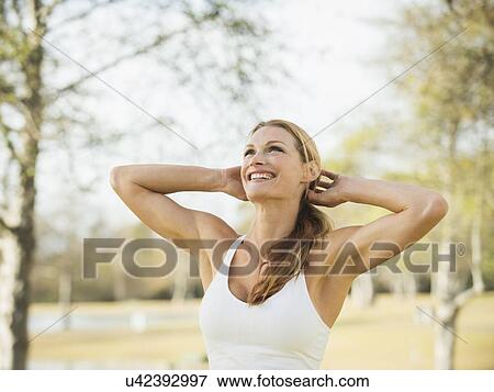 Woman smiling and looking up View Large Photo Image Stock Photo - Woman smiling and looking up. Fotosearch
