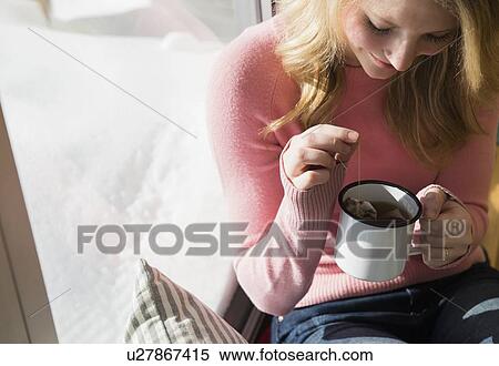 Stock Photography - Woman steeping tea in mug. Fotosearch