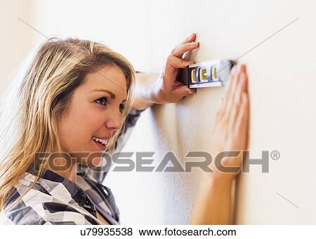 Woman using level View Large Photo Image Stock Photo - Woman using level. Fotosearch