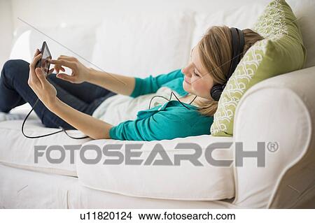 Woman watching movie on smart phone View Large Photo Image Picture - Woman watching movie on smart phone. Fotosearch