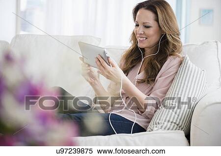 Woman watching on digital tablet View Large Photo Image Stock Photography - Woman watching on digital tablet. Fotosearch