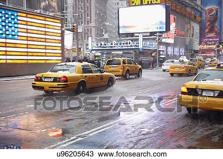 Stock Image - Yellow taxis on Time Square. Fotosearch