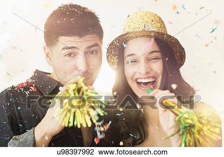 Young couple celebrating New Year's Eve View Large Photo Image Stock Image - Young couple celebrating New Year's Eve. Fotosearch