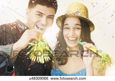 Young couple celebrating New Year's Eve View Large Photo Image Stock Photograph - Young couple celebrating New Year's Eve. Fotosearch