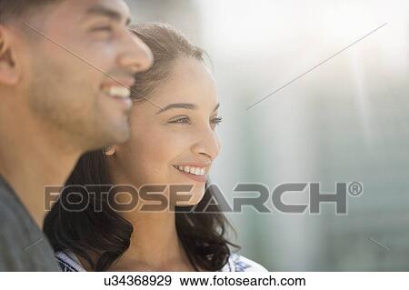 Stock Photo - Young couple smiling in sunlight. Fotosearch