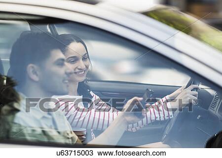 Stock Image - Young couple traveling in car. Fotosearch