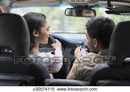 Young couple traveling in car View Large Photo Image Stock Photography - Young couple traveling in car. Fotosearch