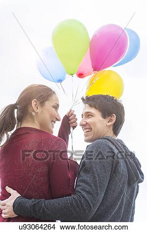 Picture - Young couple with balloons. Fotosearch