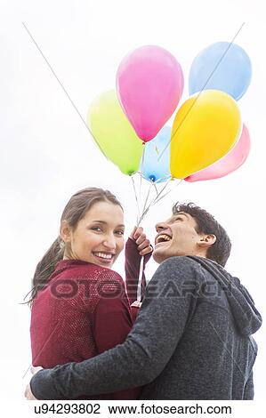Young couple with balloons View Large Photo Image Stock Image - Young couple with balloons. Fotosearch
