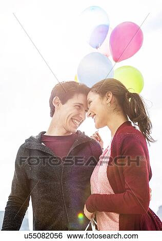 Young couple with balloons View Large Photo Image Stock Photograph - Young couple with balloons. Fotosearch