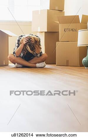 Young woman during moving into new house View Large Photo Image Picture - Young woman during moving into new house. Fotosearch