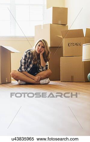 Young woman during moving into new house View Large Photo Image Stock Photography - Young woman during moving into new house. Fotosearch